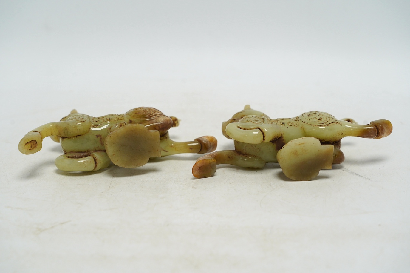 A pair of Chinese green jade horses, Han style, cased, 15cm wide. Condition - good